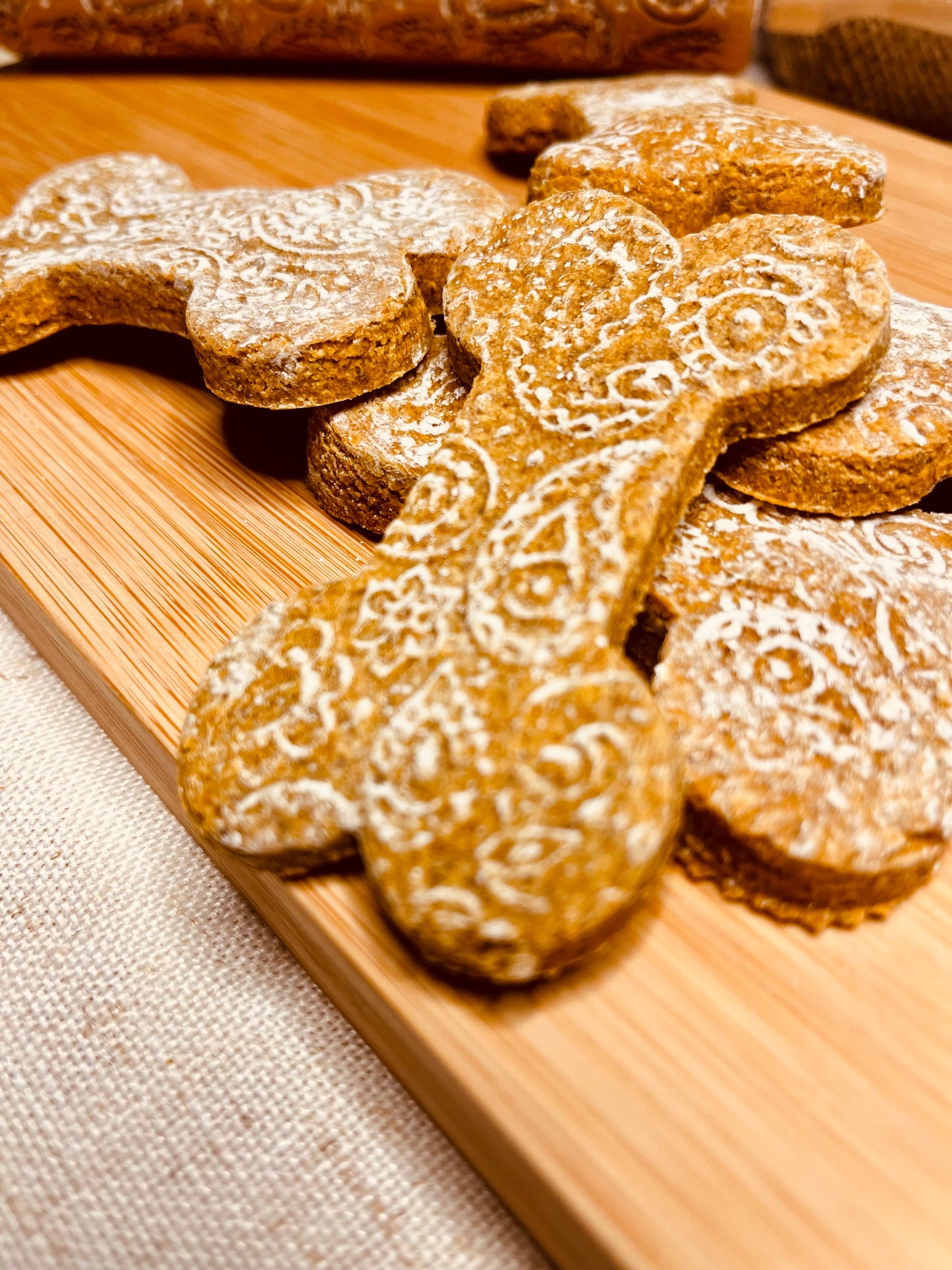 Ellie's Big Prairie Peanut Butter dog bone treats with intricate white icing decoration - organic Montana dog cookies