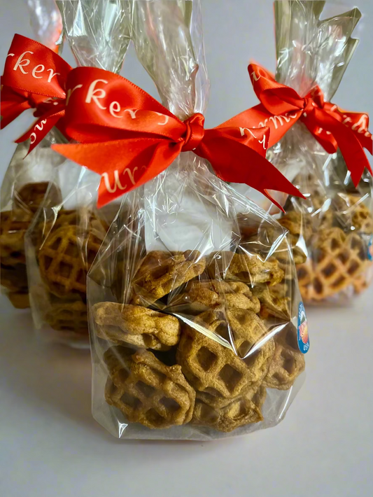 Ellie's Gourmet Barkery pumpkin woofles dog treats in clear cello bags with orange branded ribbons - seasonal waffle-shaped treats made in Montana