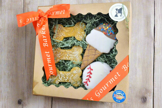 Ellie's Gourmet Barkery monthly themed dog treat gift box with decorated cookies and orange ribbon - seasonal gourmet dog treats made in Montana