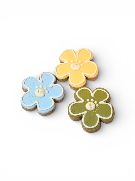 Hand-decorated spring flower dog treats made in Montana with Big Prairie Peanut Butter, yogurt-based natural color icing, and 23-carat edible gold flakes.